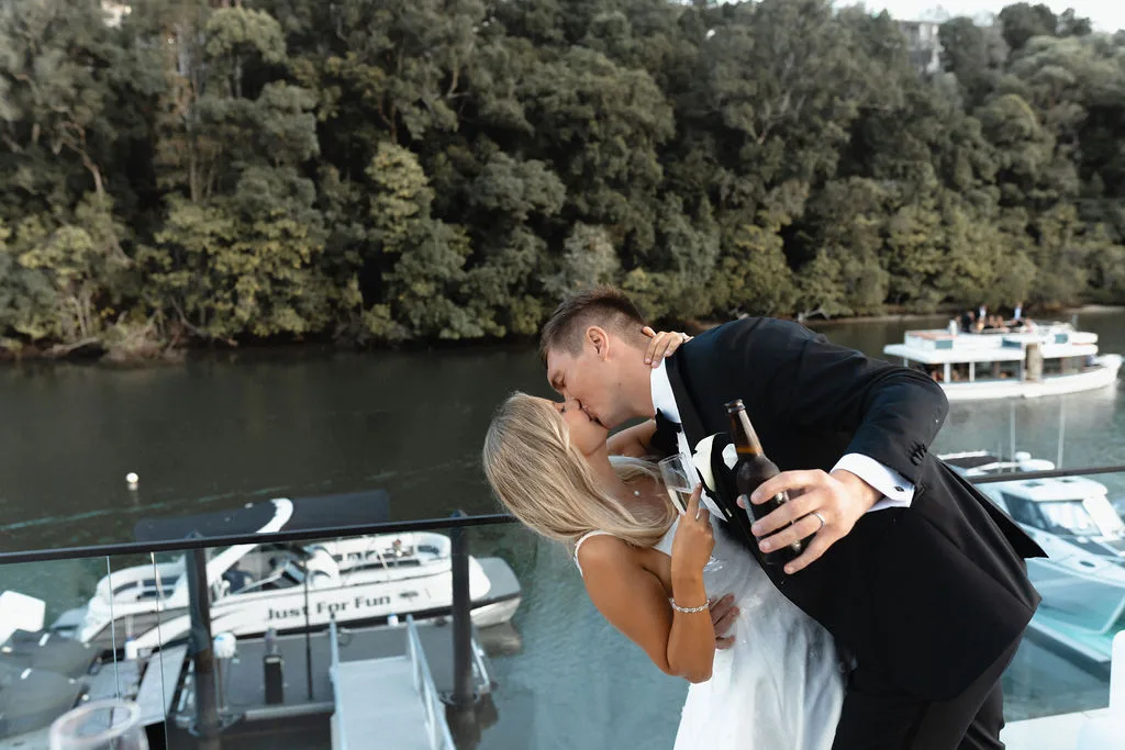 Couple by the private boat at dusk on the Noosa River
