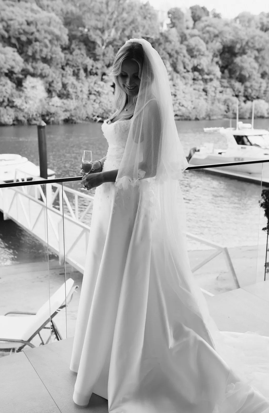 Bridal portrait on the waterfront deck, pensive moment