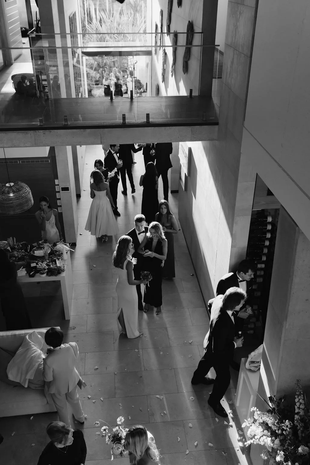 Black and white interior reception through the double-height atrium